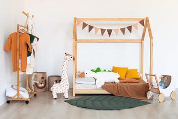 Kids room interior in contemporary, Scandinavian style. Wooden bed, sofa and toys. Cozy room for child. - 749984511