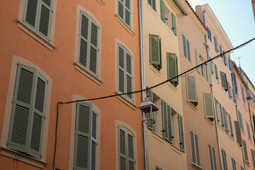 Fototapeta na wymiar Romantic backstreet road alley in historic old town downtown Toulon, France with Mediterranean style house building facades and old little piazzas fountains picturesque city scenery