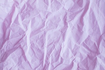 Crumpled craft paper background. Texture of purple packaging crumpled paper, top view, copy space