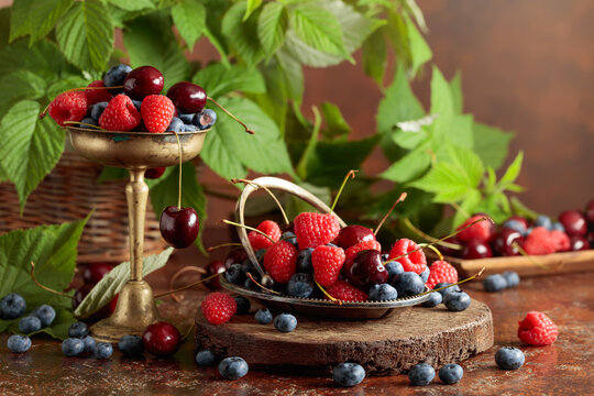 Berries with leaves on an old brown table.