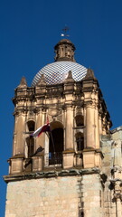 Fototapeta na wymiar Tiled bell tower on the Church and Convent of Santo Domingo de Guzman in Oaxaca, Mexico