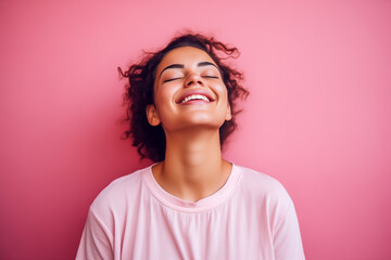 Portrait of beautiful grateful young woman isolated on pink background