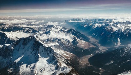 Obraz premium Beautiful snowy mountain peaks, blue sky with clouds