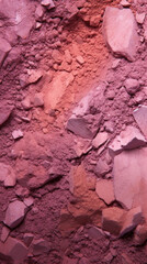 Macro texture of crushed pink blush powder highlighting various shades and makeup quality.