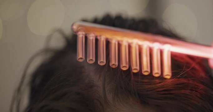 Hair Care. Woman receives a Procedure using the Darsonval device at home. Close-up of the Head. Concept of professional Cosmetology