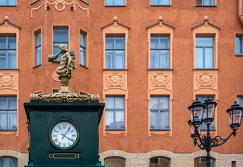 An antique clock on a pedestal in the city square.