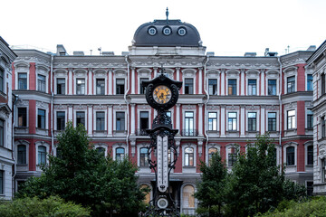 An antique clock on a pedestal in the city square.
