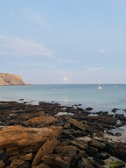 Moon light reflection at the ocean surface, rocky ocean coast