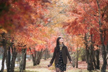 Portrait of a young Asian woman with autumn leaves