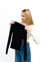 Blonde girl with a black jumper on a white background. - 750020713