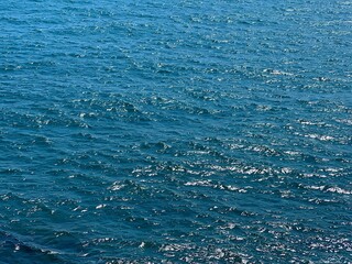Blue sea water glittering calm surface. 
