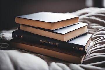 stack of books lying on a bed - obrazy, fototapety, plakaty