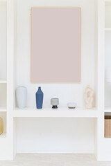 Fototapeta na wymiar white shelf with blank art frame and vase