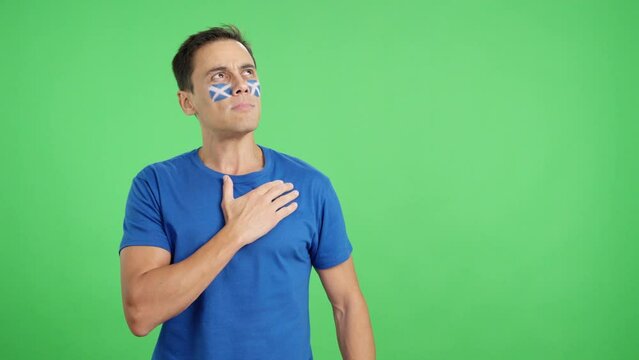Man listening to the Scotland national anthem with solemnity