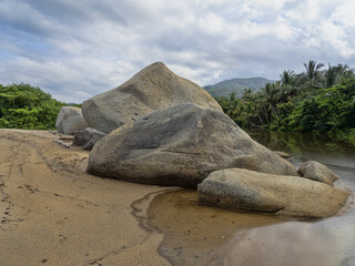 Fototapeta na wymiar Graceful boulders on the coast in Tayrona National Park. Colombia