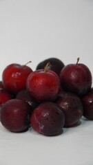 Fresh red plums isolated on a white background