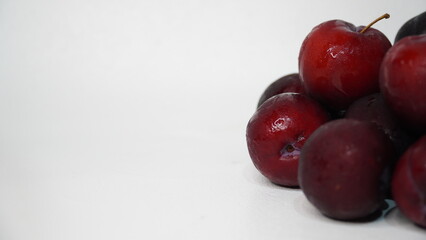 Fresh red plums isolated on a white background