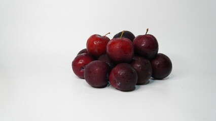 Fresh red plums isolated on a white background