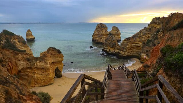 Algarve coast in Lagos, Portugal, Praia do Camilo with wooden stairs to the beach at the Atlantic Ocean.