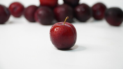 Fresh red plums isolated on a white background