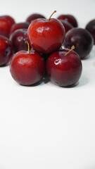 Fresh red plums isolated on a white background