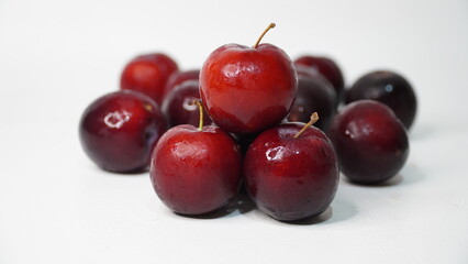 Fresh red plums isolated on a white background