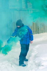 Boy with a stick of colored smoke