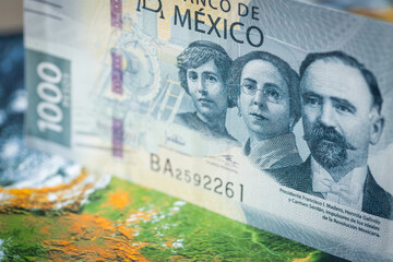 mexico money, 1000 mexican pesos banknote against the background of the world, financial market concept