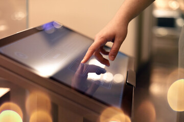 Woman using interactive touchscreen display. Education and technology concept