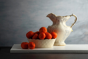 mandarin oranges in a white porcelain bowl - 750056515