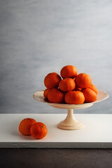 mandarin oranges on a vintage cake stand
