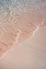 Wave on the beach with pink sand, seascape