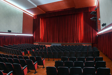 Empty theatre with red curtains stage in lights
