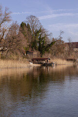 As the sun begins its descent, the lake takes on a golden glow, the reflection of the fading day painting the waters with warm hues. 