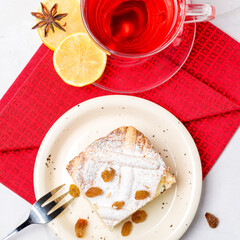 Homemade cheesecake with raisins. Pieces of cheesecake with raisins and lemon slices and tea