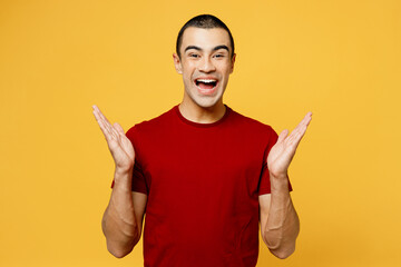 Young happy fun excited overjoyed middle eastern man he wear red t-shirt casual clothes spread...