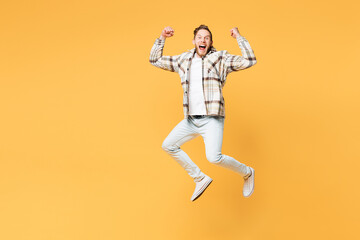 Fototapeta na wymiar Full body overjoyed happy young Caucasian man he wear brown shirt casual clothes jump high do winner gesture look camera isolated on plain yellow orange background studio portrait. Lifestyle concept.
