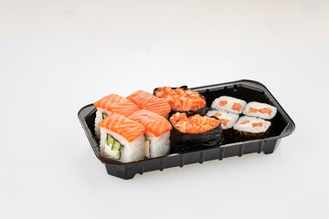 Close-up of sushi rolls made of sausage and covered with cabbage and ketchup. Homemade asian style. Sushi-food hybrids trend. Japanese food.