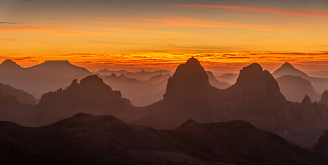 Hoggar landscape in the Sahara desert, Algeria. A view from Assekrem of the sunrise over the Atakor mountains - 750080322