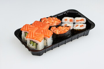 Close-up of sushi rolls made of sausage and covered with cabbage and ketchup. Homemade asian style. Sushi-food hybrids trend. Japanese food.