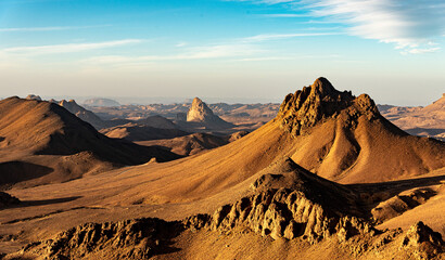 Hoggar landscape in the Sahara desert, Algeria. A view from Assekrem of the mountains and basalt organs that rise up in the morning light. - 750080705