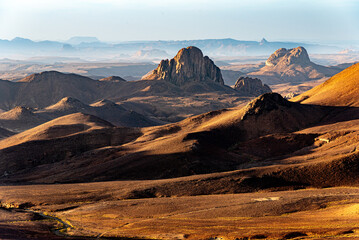 Hoggar landscape in the Sahara desert, Algeria. A view from Assekrem of the mountains and basalt organs that rise up in the morning light. - 750080786
