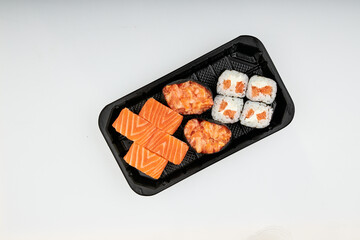 Close-up of sushi rolls made of sausage and covered with cabbage and ketchup. Homemade asian style. Sushi-food hybrids trend. Japanese food.