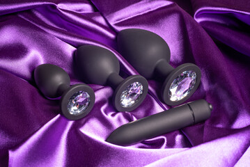 four mismatched silicone black anal plugs with crystals