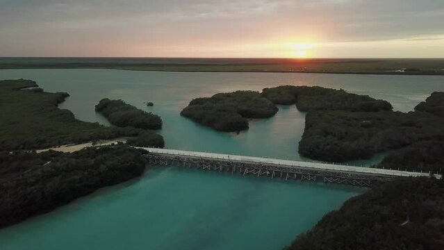 Aerial view of the SIan Kaan reserve right at the only bridge that there is in the way to Punta Allen, at sunset, Drone moves forward Sian Kaan Reserve, Quintana Roo, Mexican Caribbean