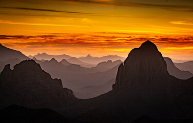 Hoggar landscape in the Sahara desert, Algeria. A view from Assekrem of the sunrise over the Atakor mountains - 750081921