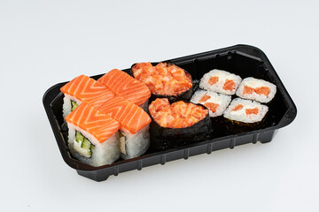 Close-up of sushi rolls made of sausage and covered with cabbage and ketchup. Homemade asian style. Sushi-food hybrids trend. Japanese food.