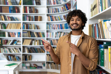 A man, elegantly dressed, is confidently pointing at something unseen in a library. His posture suggests a presentation or a guide in an educational setting surrounded by an array of books.