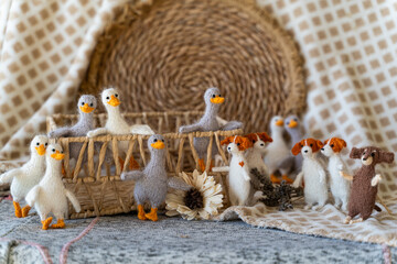group of knitted gray and white geese toys with yarn and knitting accessories