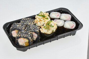 Close-up of sushi rolls made of sausage and covered with cabbage and ketchup. Homemade asian style. Sushi-food hybrids trend. Japanese food.